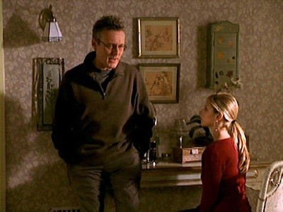 Giles leans on Buffy's vanity to talk to her about her date