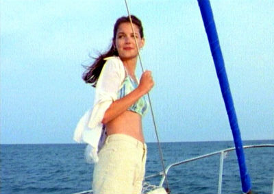 Joey stands on the boat, looking over her shoulder