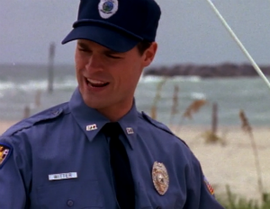 Pacey's brother Doug in police uniform on the beach
