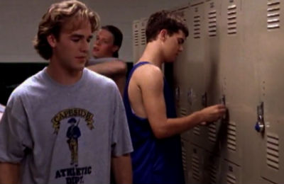 Dawson and Pacey in the locker room. Pacey's wearing a tank top that shows off his no-biceps