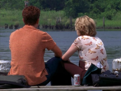 Pacey and Jen sit together, looking at the water