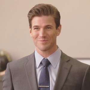 Austin Stowell, a handsome white actor in a tie and suit jacket, as Josh