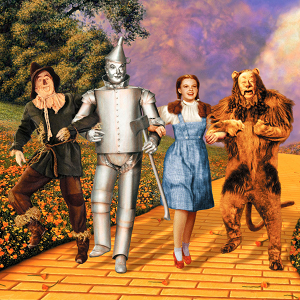 The characters of Wizard of Oz with arms linked, walking down the yellow brick road