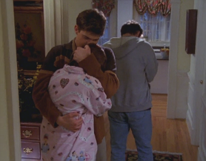 Pacey hugs a trembling Andie to his chest, cradling her head