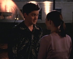 Pacey stands outside with Andie, wearing a velour collared paisley shirt. It's hideous.