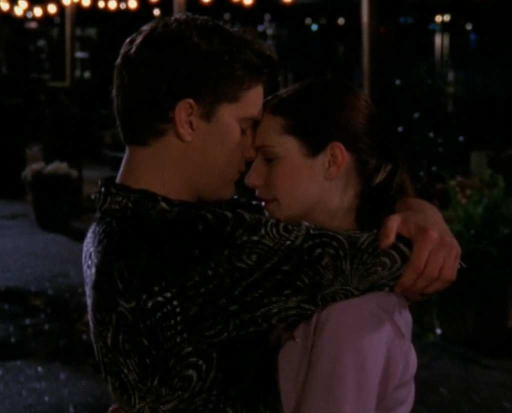 Pacey hugs Andie to him on the pier, kissing her forehead