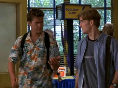 Pacey and Dawson are in the school hallway, and Pacey's wearing a hideous orange and blue Hawaiian shirt two sizes too big for him