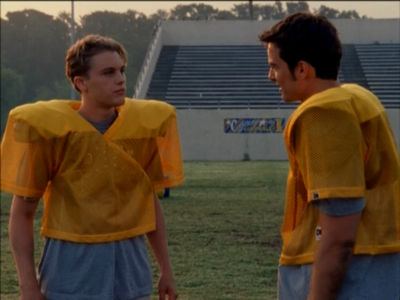 Jack and Michael Pitt as Henry in football practice gear on a field