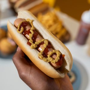 Hand holding a hot dog