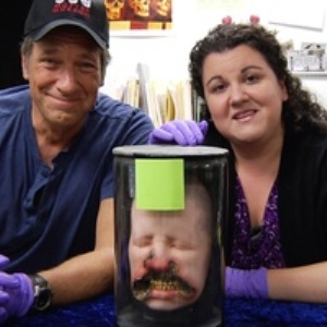 Mike Rowe, host of 'Dirty Jobs' and a Mütter Museum employee pose with a human head in a jar