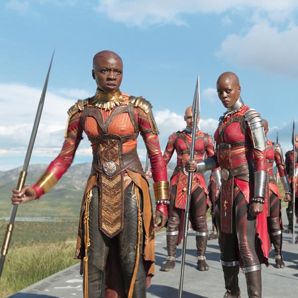 Screenshot from Black Panther of a group of fierce, bald, Black female warriors in sleek armor
