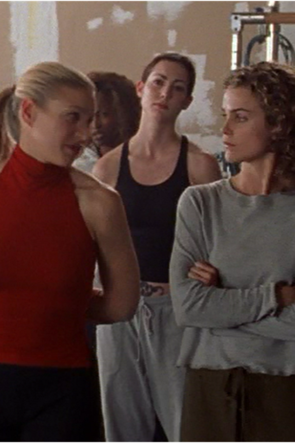 Avery and Felicity in fitness clothes looking at each other