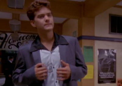Pacey wears a striped bowling shirt with a huge collar