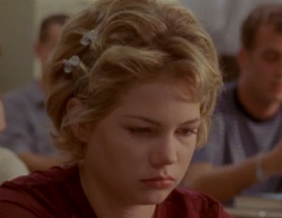 Jen's got a short, curly, very '90s haircut pinned back with butterfly barettes