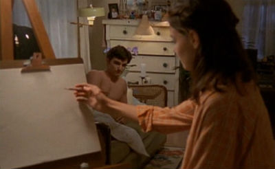 Joey draws Jack, who is naked but mostly hidden by her easel. They both look nervous.