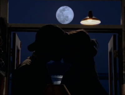 Jack and Joey kiss by the window, bathed in the light of a full moon