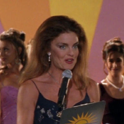 Tracy Scoggins, an older white woman with brown hair and sharp cheekbones
