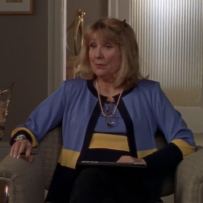Teri Garr, a middle-aged white blonde woman, as Dr. Zwick, wearing a professional outfit and sitting in a chair
