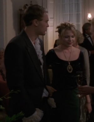 Jen and Henry at the gala, Jen in a black crushed velvet gown with her hair tied up in spunky knots, and Henry in a black jacket and ruffled shirt