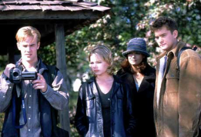 Dawson, holding a video camera, is joined by Jen, Joey and Pacey on a sunny day in the woods