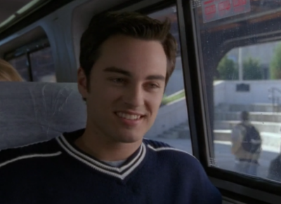 Jack sits on a bus, smiling big