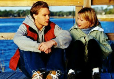 Henry and Jen sit on the pier, both looking like preppy J Crew ads, having a solemn talk