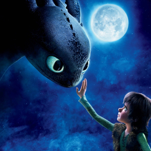 Characters from How to Train Your Dragon; a young boy touches a dragon's face under moonlight