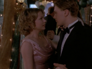 Jen and Henry dance at the prom. She looks beautiful in a pale pink old-fashioned gown with Hollywood curls, and he's wearing a suit. 