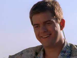 Pacey, standing in front of a lovely blue sky, smiles down at Joey (off-camera) with the happiest, most disbelieving expression on his cute face.