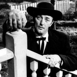 Black and white still of Robert Mitchum in The Night of the Hunted, where he plays a psycho minister