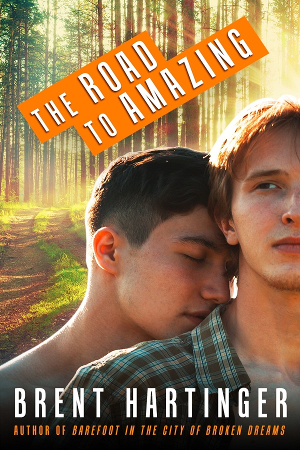 Cover of The Road to Amazing by Brent Hartinger. Two twenty something white guys snuggle in a forest