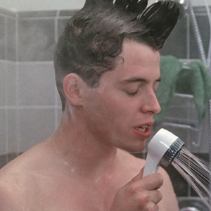 Ferris Bueller singing in the shower with a shampoo mohawk.