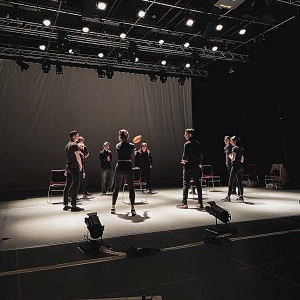 A theater troupe practicing on stage
