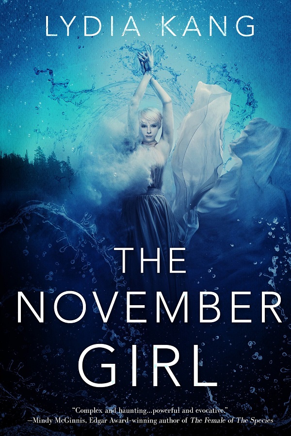 Cover of The November Girl by Lydia Kang. An almost albino girl poses underwater with pine trees in the background