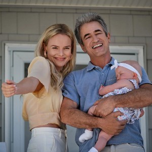 Heidi, a pretty blonde, with her older husband, Robert, who is holding their baby 
