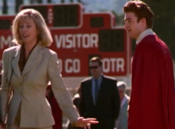 A different blonde lady walking away from Ben at his high school graduation