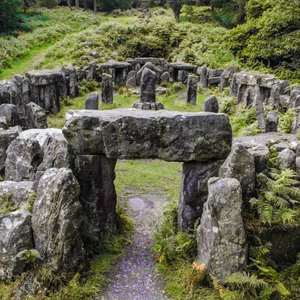 An entry way of stone to an open circle of stone pillars. 