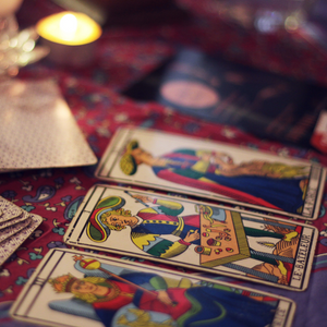 3 tarot cards displayed in a row on a table