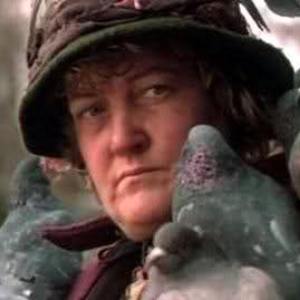 An older woman holding a pigeon; the homeless bird lady from Home Alone 2