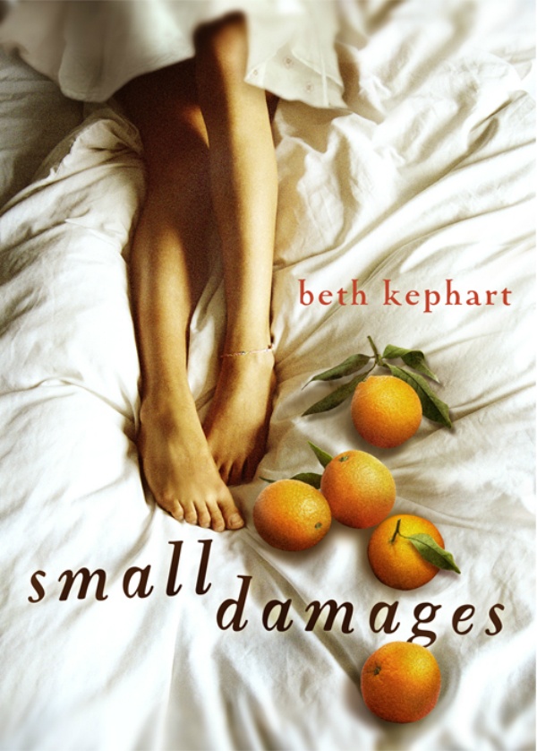 A woman's bare legs on white bedsheets with a pile of oranges next to her feet.