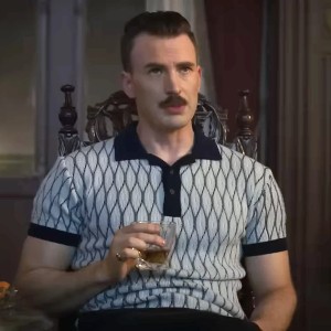 Chris Evans, a handsome white brunette man, with a mustache and muscled arms