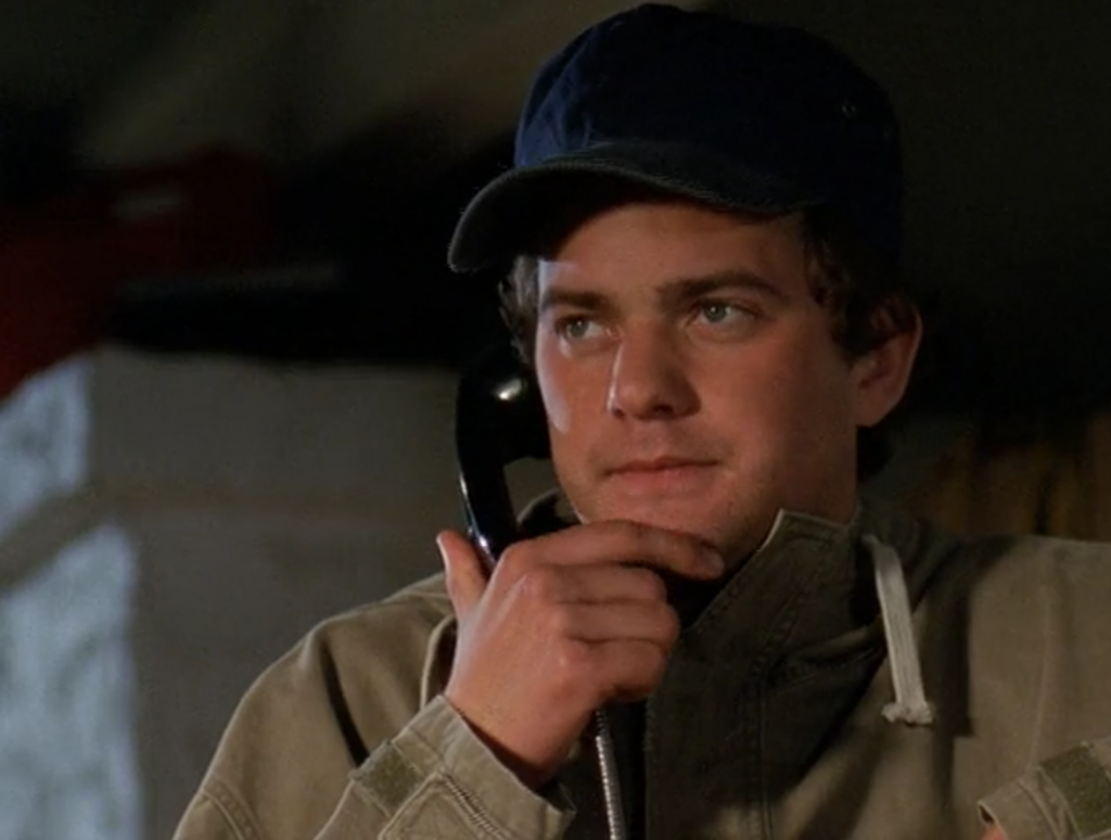 Pacey's wearing an oversized ballcap and a khaki jacket and looks like an '80s dad