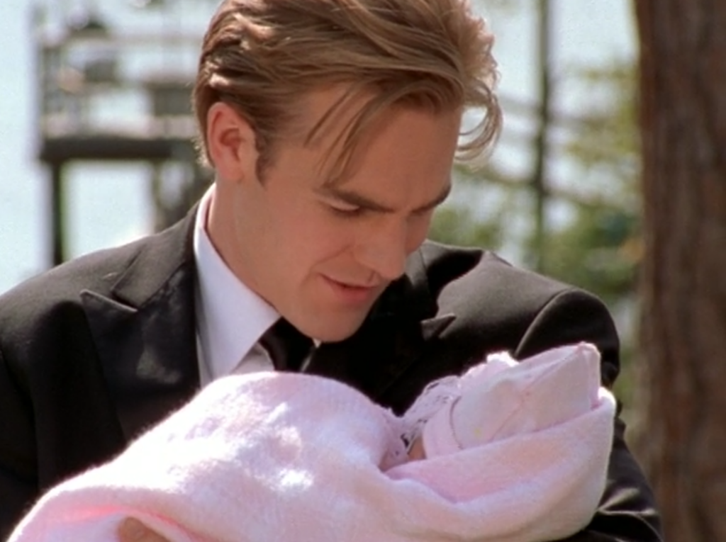 Dawson, in his tux for prom, holding Lillian and smiling down at her