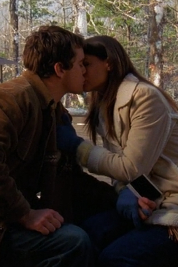 Joey and Pacey sit on a bench, kissing in the snow