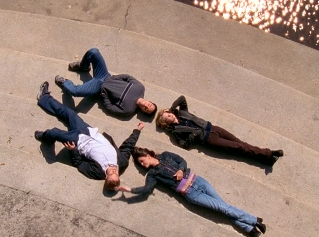 A birdseye shot of Jack, Jen, Joey and Dawson lying on their backs outside on stone steps