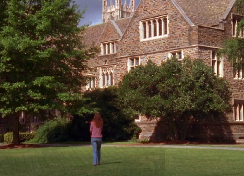 Joey stands in front of an imposing university building, looking up