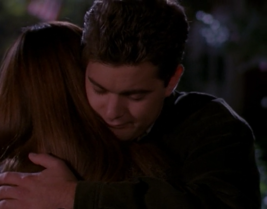 Pacey hugs Joey tight with a sweet look on his face