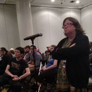 A stern looking Sandy at a panel