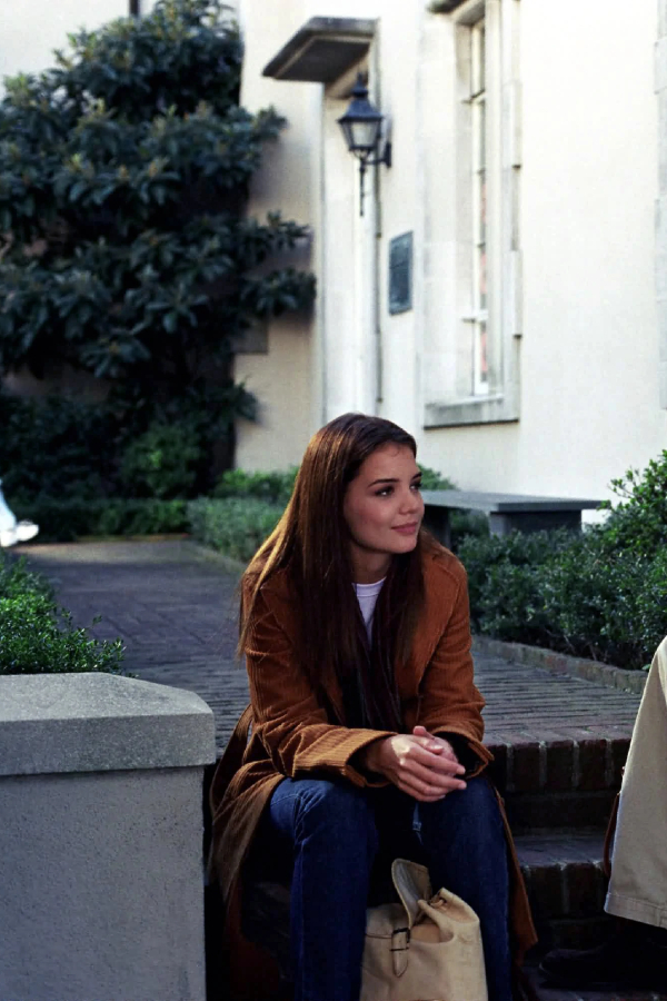 Joey, sitting on a stop on campus, smiling at something off-camera (it's her professor)