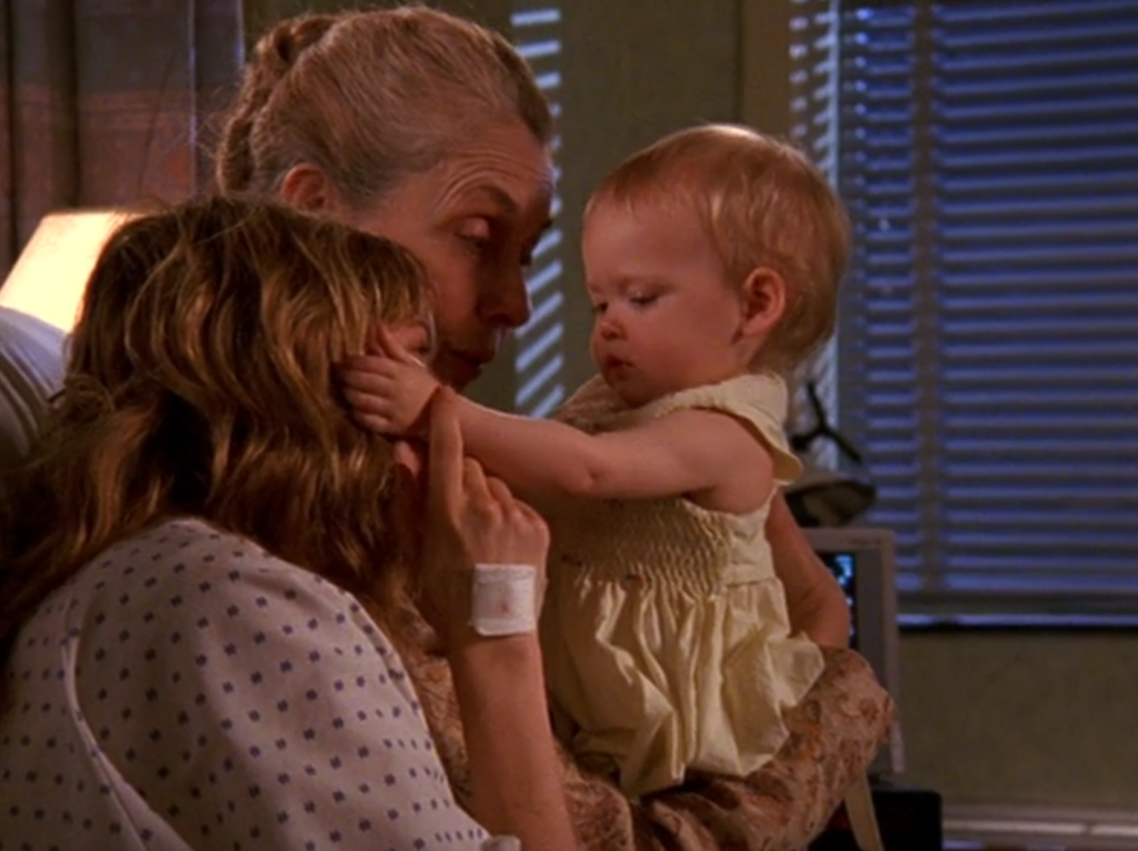 Jen, in a hospital gown, and Grams cuddle little baby Amy